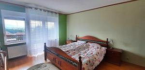 a bedroom with a bed and a large window at Dom Borowski in Bukowiec