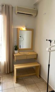 a bathroom with a sink and a mirror at Lemon Art Hotel Apartments in Tolo