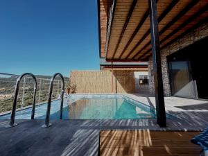 a house with a swimming pool with a roof at Belen nature&lodge in Kumluca