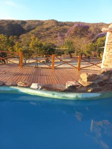a view of a pool with a wooden deck at pousada solar da canastra in Delfinópolis