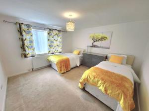 a bedroom with two beds and a window at Stunning! 3 Bed Entire House with Free Parking in Stapleford