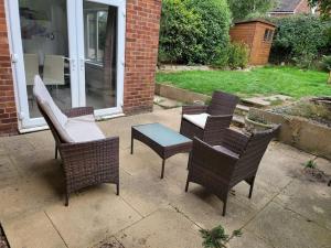 a group of chairs and a table on a patio at Stunning! 3 Bed Entire House with Free Parking in Stapleford