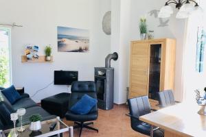 a living room with a couch and a wood stove at OstseeFreiheit in Bodstedt