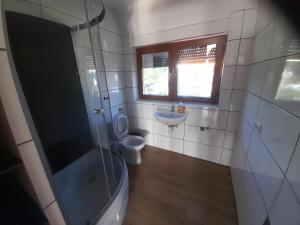 a bathroom with a toilet and a sink at Monteurzimmer KM in Delbrück +2 photos