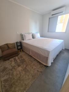 a bedroom with a large bed and a window at AP CENTRO Campinas in Campinas