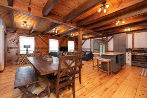 a large living room with a table and a kitchen at RIVER! Hot tub, Movie theater, Sauna, Massage chair in Conway