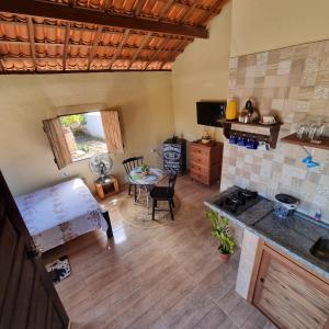 an aerial view of a kitchen and living room with a table at Chalé Raiz da Serra in Gravatá +31 photos
