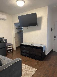 a living room with a flat screen tv on the wall at Radiant Retreat #7 in Daytona Beach