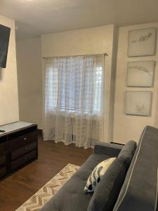 a living room with a couch and a window at Radiant Retreat #7 in Daytona Beach