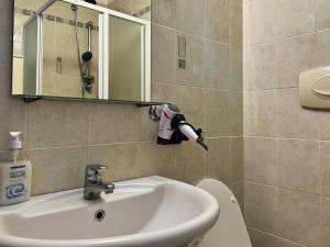 a bathroom with a sink and a mirror at Acquatica House - San Siro District in Milan