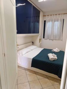 une chambre avec un lit avec deux serviettes dessus dans l'établissement La Muddizza appartement avec piscine, à Valledoria