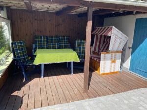 a patio with a table and chairs on a deck at Ferienwohnung Mia in Lübeck