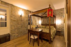 a bedroom with a bed with a wooden table and a desk at Ca' Boscodonne in Calosso