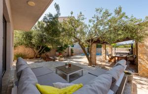 a living room with a couch and a table at Holiday house with pool and whirlpool Sara in Betina