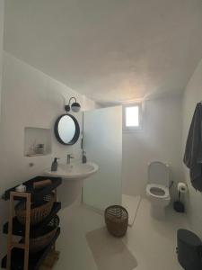 a bathroom with a sink and a toilet at Kaliora house in Methoni