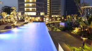 a long swimming pool in a city at night at Luxurious 1 Icon 3BR Apartment in Tunjungan Plaza 6 Surabaya City Centre by Le Ciel Hospitality in Surabaya