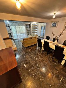 a living room with a couch and a table and chairs at Casa Amparo in Jávea +19 photos