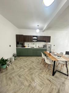 a kitchen and dining room with a table and chairs at Loft ËNXË Boutique Habitación Blue in Cuetzalán del Progreso