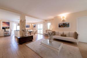 a living room with a couch and a table at Villa Mastrissa Taormina in Taormina
