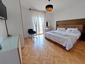 a bedroom with a large bed and a television at Holiday house with pool and whirlpool Sara in Betina +94 photos