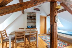 a dining room with a wooden table and chairs at Dachwohnung am Schlosspark in Wiesbaden