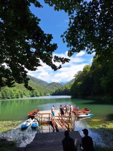 a group of people on a dock on a lake at Camp Mrdak Lipovo in Kolašin