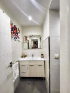 a bathroom with a sink and a mirror at Casa de Arena 1 in Nigrán +28 photos