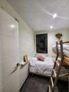 a small bedroom with a bunk bed and a window at Casa de Arena 1 in Nigrán
