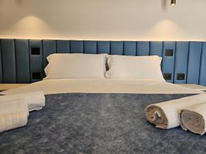 a bedroom with a large bed with towels on it at Gabbiano Suites in Cervia