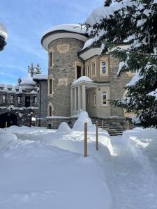 a large building with snow in front of it at WEF 2026 Exclusive 160mq Castle Apartment in Davos -now available again in Davos