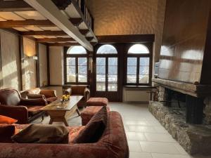 a large living room with couches and a fireplace at WEF 2026 Exclusive 160mq Castle Apartment in Davos -now available again in Davos