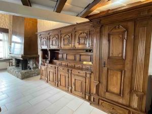 a large kitchen with wooden cabinets and a fireplace at WEF 2026 Exclusive 160mq Castle Apartment in Davos -now available again in Davos