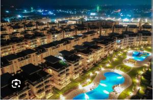 an aerial view of an apartment complex at night at فيلا رائعة فرش مودرن على بحر مارينا دلتا in Al Ḩammād +11 photos