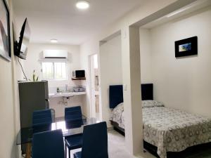 a bedroom with a bed and a table and chairs at Casa Aura in Isla Mujeres +39 photos