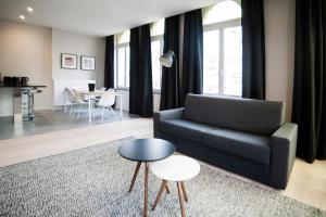 a living room with a couch and a table at Smartflats - Meir Antwerp in Antwerp