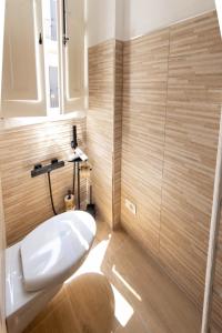 a bathroom with a white sink and wooden walls at casa turistica l'etoile in Conversano +47 photos