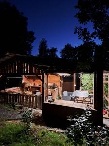a pavilion with a table and a couch on it at Rózsakert Apartman in Zalaszentgrót