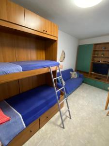 a bedroom with a bunk bed and a couch at Casavacanze Onda Blu in Mascali +17 photos