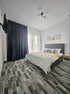 En eller flere senge i et værelse på Lakeview Apartament