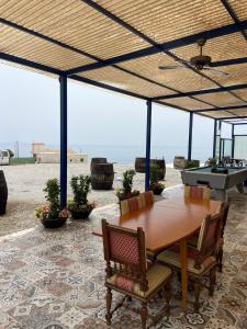 a table and chairs on a patio with a view of the ocean at Bonitas vistas al mar in Almería +34 photos