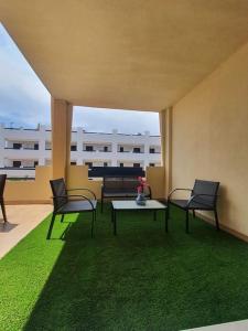 a room with two chairs and a table on a patio at Paraíso Vera Playa in Playas de Vera