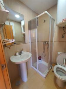 a bathroom with a shower and a sink and a toilet at Paraíso Vera Playa in Playas de Vera +10 photos