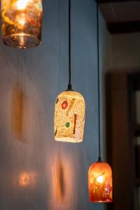 aendant light hanging from a wall with three lights at Palazzo San Luca in Venice