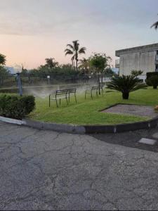 a group of benches sitting in a park at Casavacanze Onda Blu in Mascali