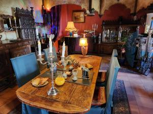 a wooden table with food on it in a room at La Chaumière magique des Elfes et son escape game in Servas +34 photos