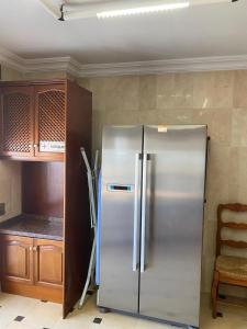 a stainless steel refrigerator in a kitchen at Vivienda Monterreal primera línea playa in Estepona