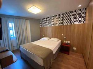 Cama o camas de una habitación en Flat Ipanema com Garagem