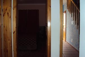 
a room with a door open and a wooden floor at Odeceixe Beach Apartments in Odeceixe
