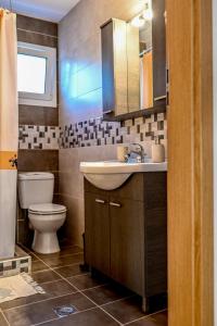 a bathroom with a sink and a toilet at morfo's sunset in Sounio +43 photos