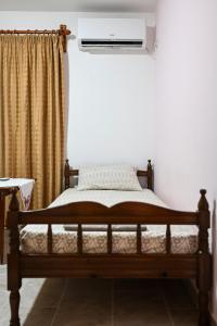 a bedroom with a bed with a air conditioner at morfo's sunset in Sounio